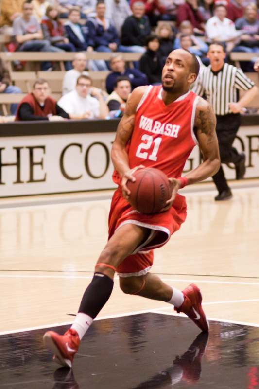 a man in a basketball uniform dribbling a basketball