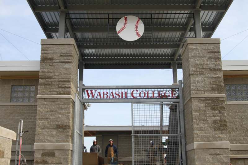 a baseball sign above a gate