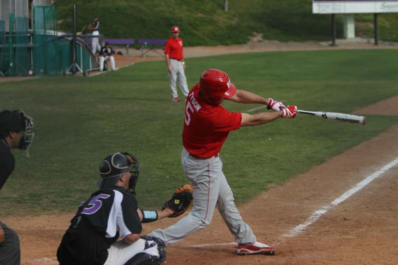 a baseball player swinging his bat