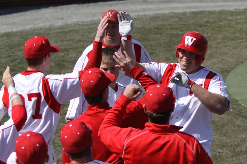 a group of baseball players high fiving