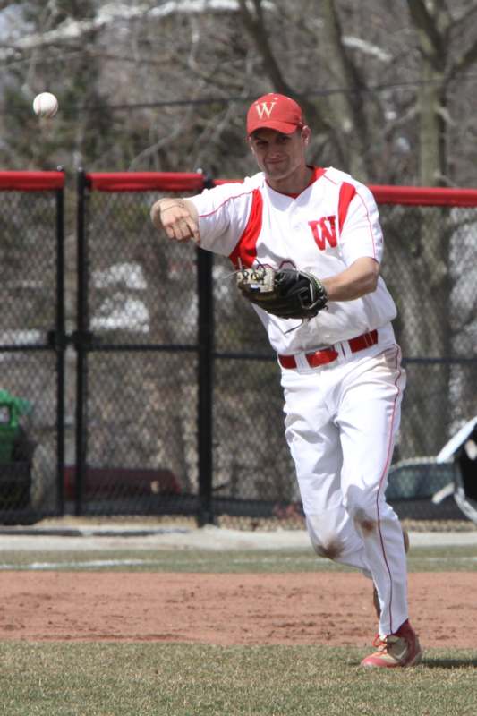 a man in a baseball uniform throwing a baseball