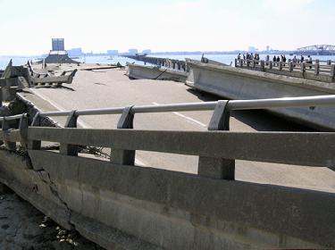 a damaged road with a large crack