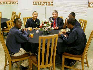 a group of men sitting around a table