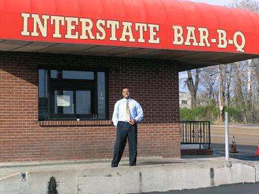 a man standing in front of a bar