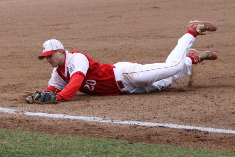 a baseball player sliding into the ground