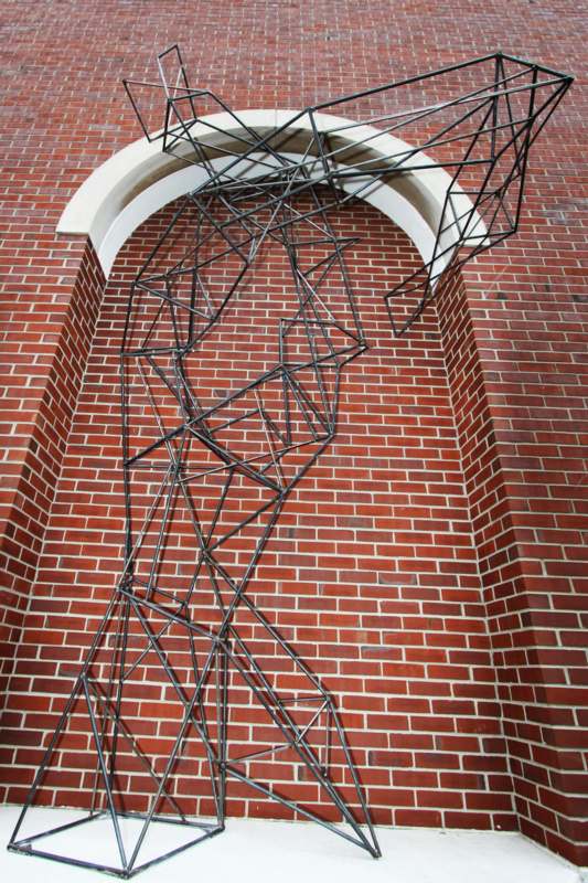 a metal structure on a brick wall