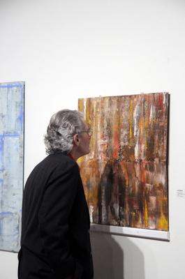 a man looking at a painting