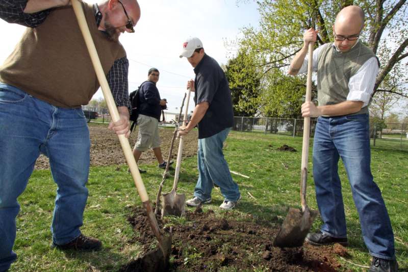 a group of men digging in the ground