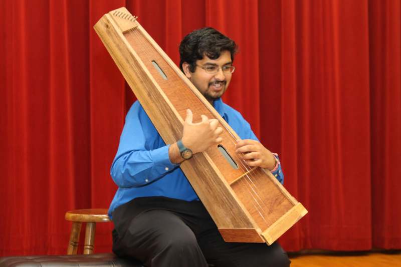 a man holding a wooden instrument
