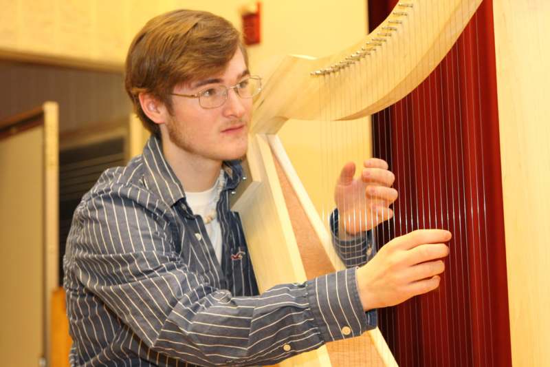 a man playing a harp