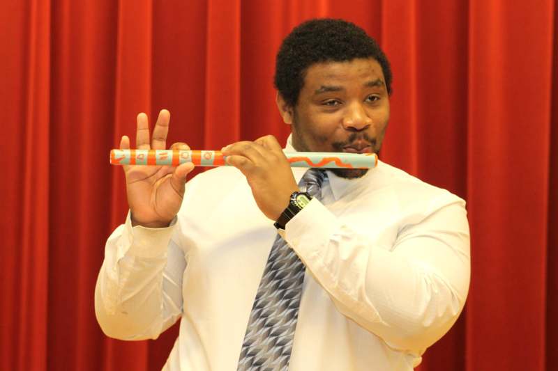 a man holding a flute