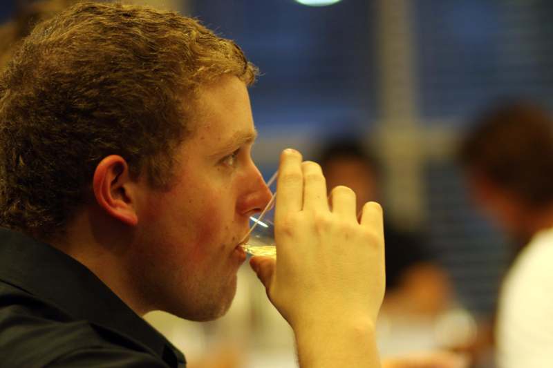 a man drinking from a glass