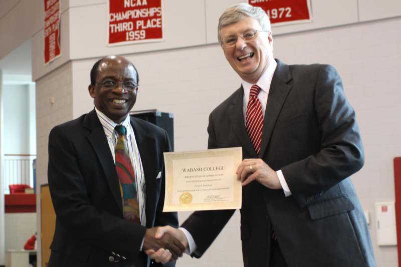 men shaking hands with a certificate