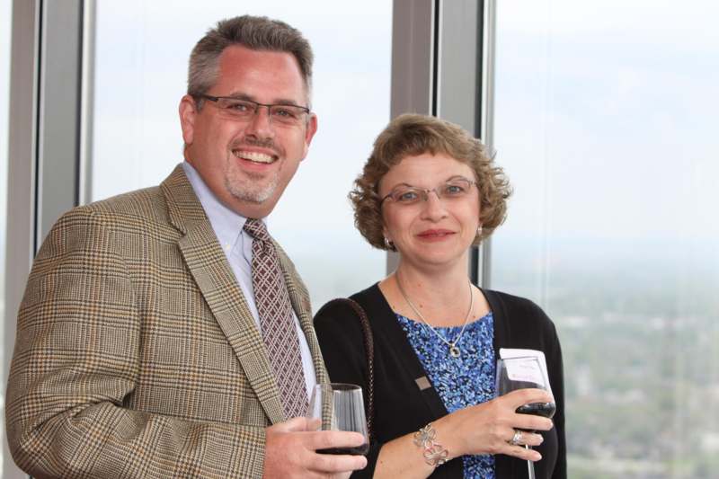 a man and woman holding wine glasses