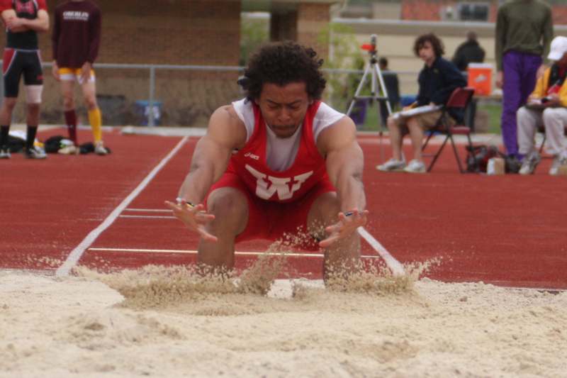 a man in a red uniform on a track