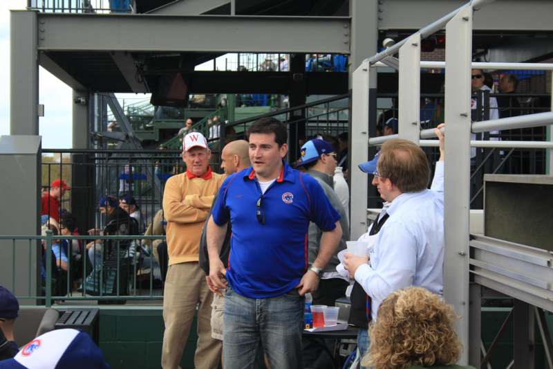 a man in a blue shirt standing in a crowd