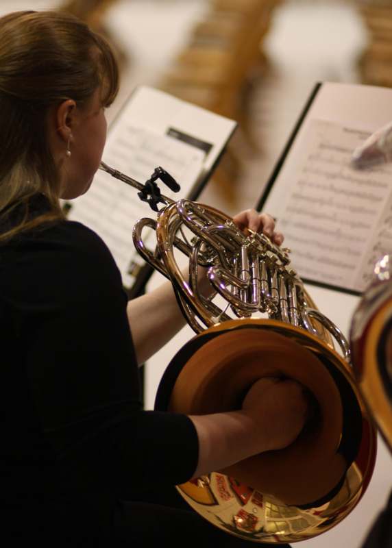a woman playing a french horn