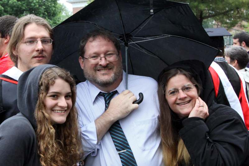 a group of people under an umbrella