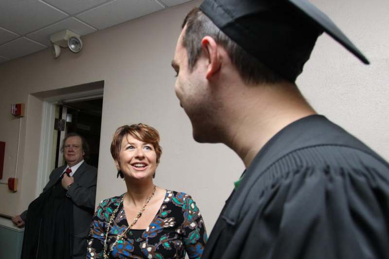 a man and woman in a graduation gown