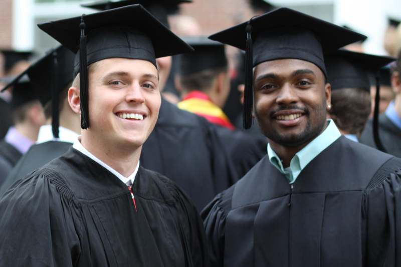 a group of men wearing graduation caps and gowns