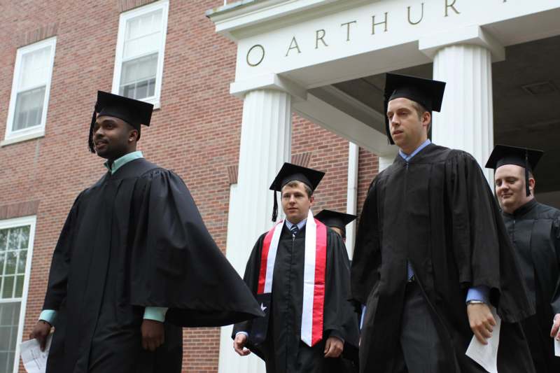 a group of men wearing graduation gowns and caps