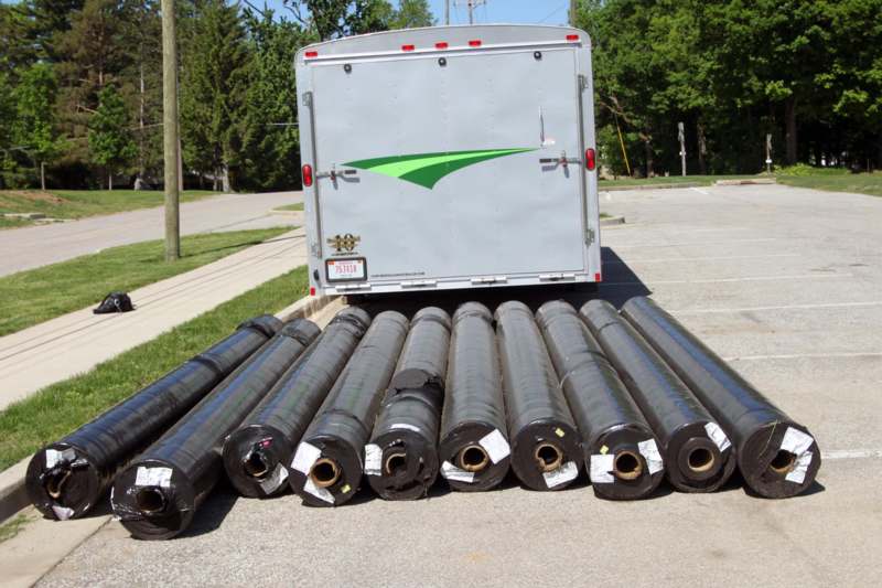 a group of rolls of black material