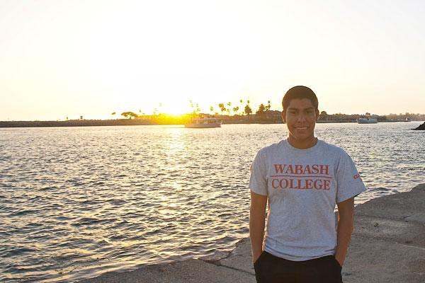 a man standing on a dock with a body of water in the background
