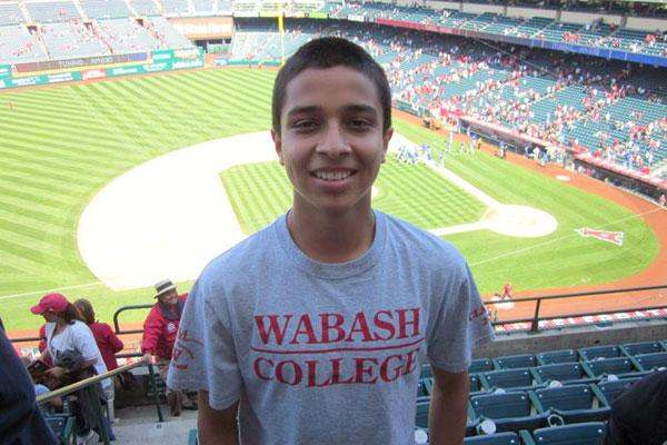 a boy standing in a stadium