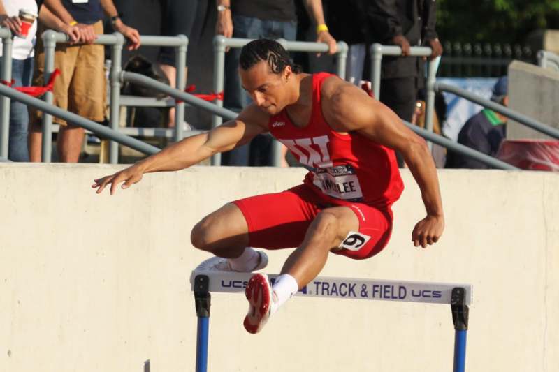 a man jumping over a hurdle