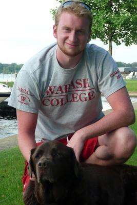 a man sitting on a bench with a dog