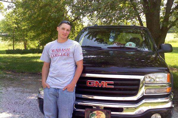 a man standing next to a black truck