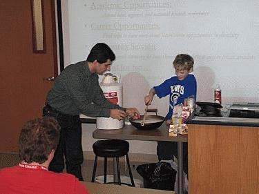 a man and boy cooking in a room