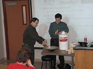 a group of men mixing food in a room