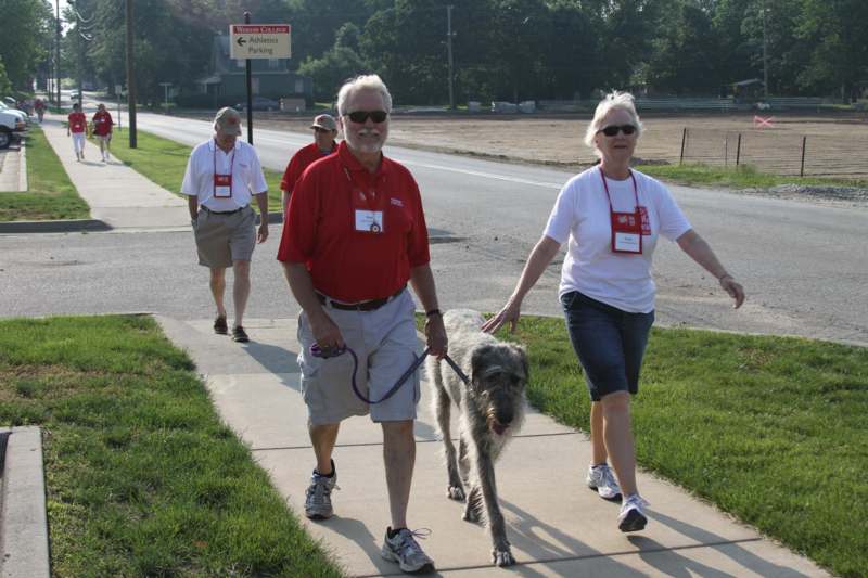 a group of people walking a dog