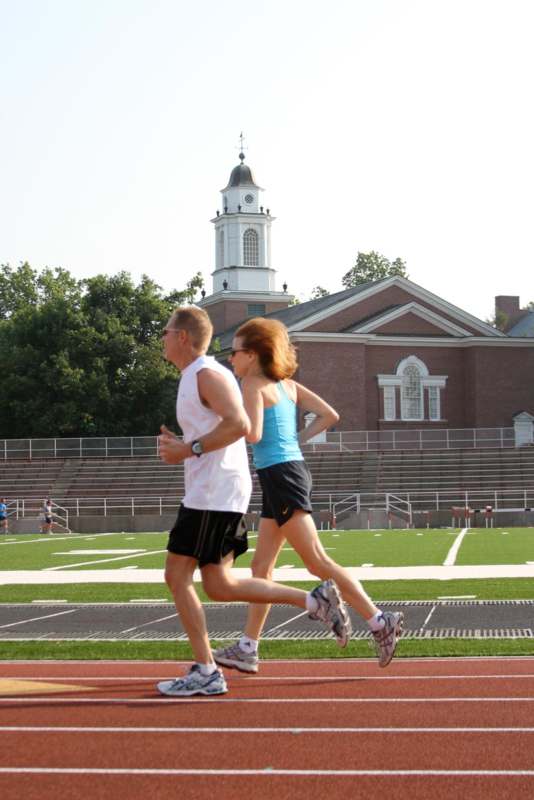 a man and woman running on a track