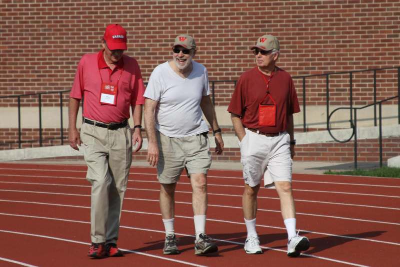 a group of men walking on a track