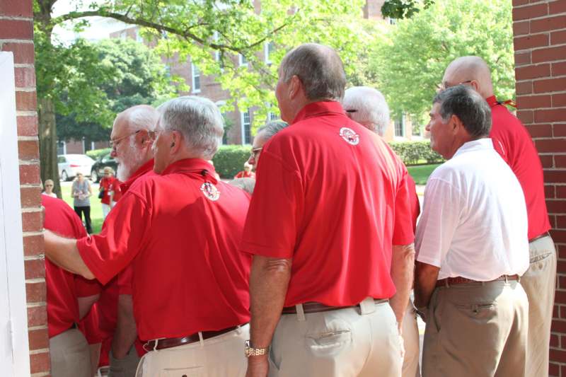 a group of men in red shirts