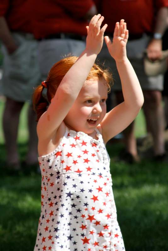 a girl with red hair and a white shirt with stars on it