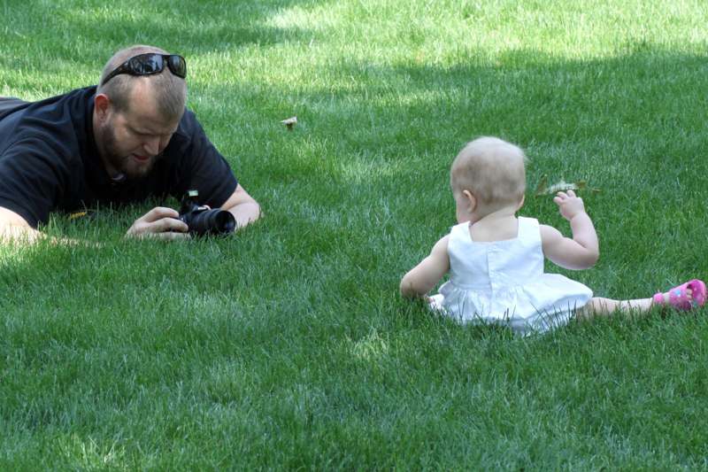 a man and baby lying in grass