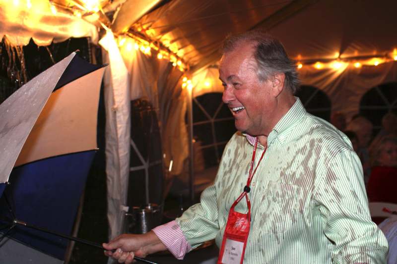 a man smiling at a tent
