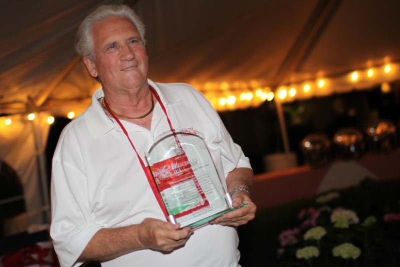a man holding a award
