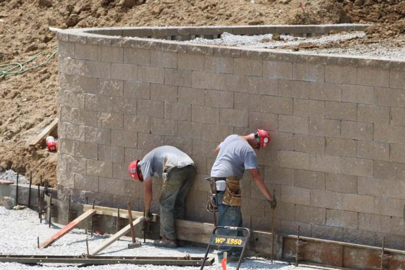a group of men working on a wall