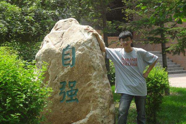 a man leaning on a rock