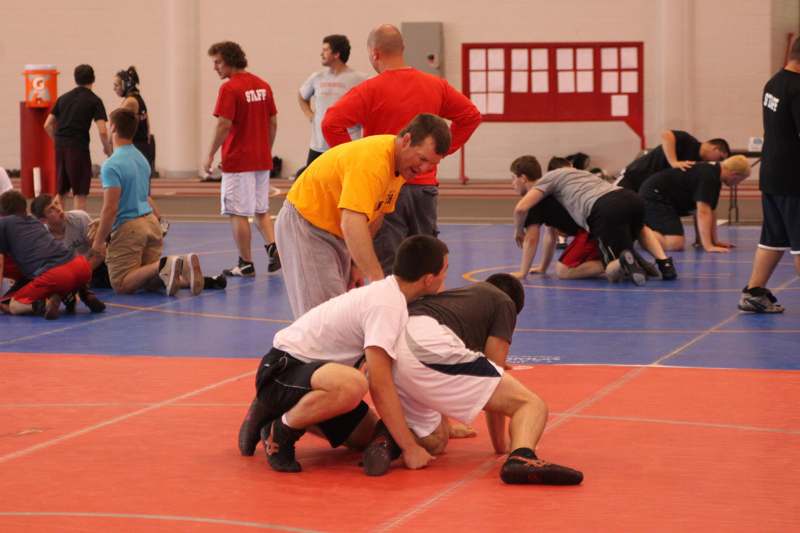 a group of people on a wrestling court