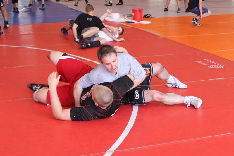 a group of people wrestling on a gym floor
