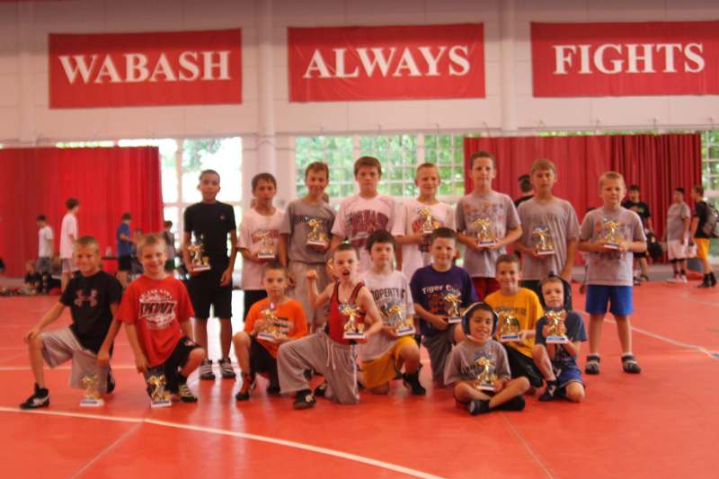 a group of kids holding trophies