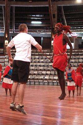 a man in red dress jumping on a wooden floor
