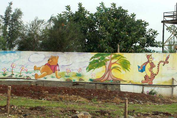 a mural of a cartoon character and a tree