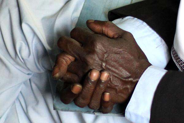 close-up of a man's hands folded together