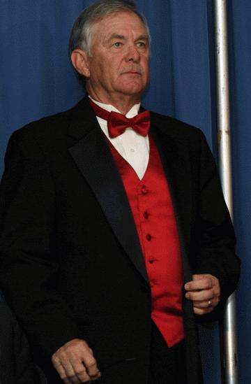 a man in a tuxedo and a red bow tie